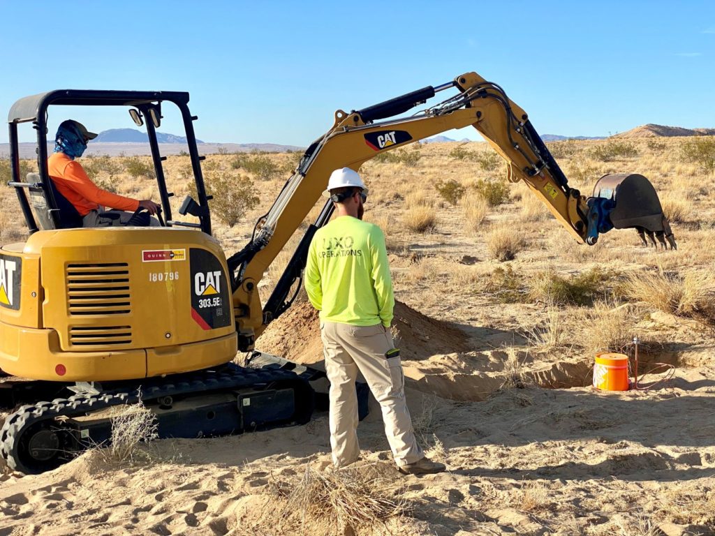 Mini-excavator working with UXO tech